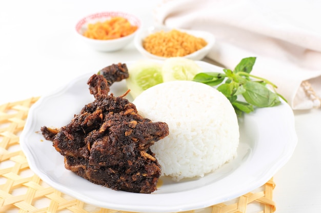 Bebek madura, traditional fried duck with maduranese typically sauce. usually served with raw vegetable and spicy sambal. popular as penyetan