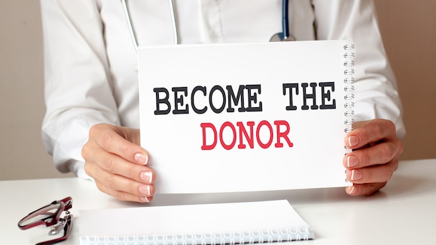 BECOME THE DONOR card in hands of medical Doctor