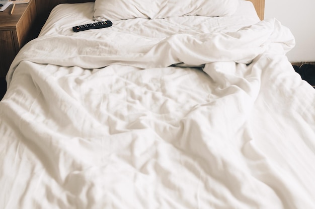 Bed made with white linens in the hotel