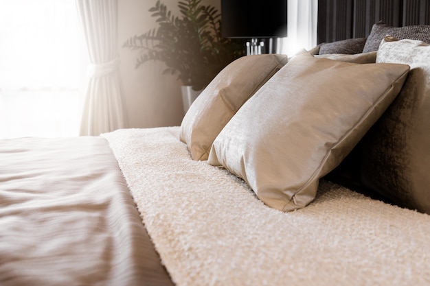 Bed maid-up with clean white pillows and bed sheets in bedroom