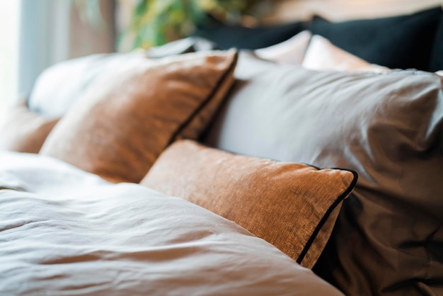 Bed maidup with clean white pillows and bed sheets in beauty
room closeup lens flair in sunlightcloseup of new bed comforter
with decorative pillows headboard in bedroom in staging model
home