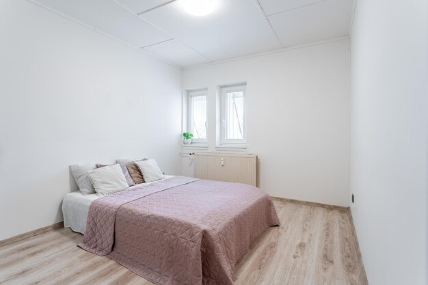 bed in a minimalist bedroom in an apartment of a residential building