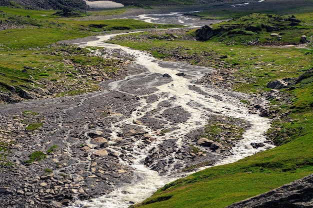 The bed of the mountain river became shallow after the flow of melt water, the dry season in the mountains.