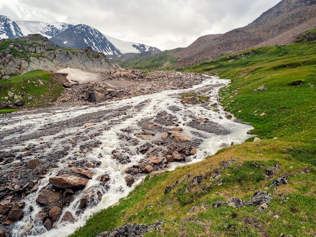 The bed of the mountain river became shallow after the flow of melt water the dry season in the mountains