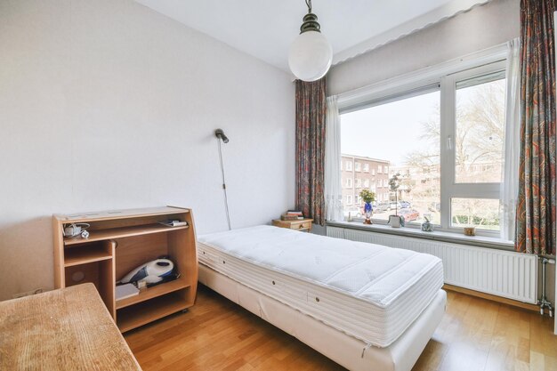 Bed near window in modern apartment