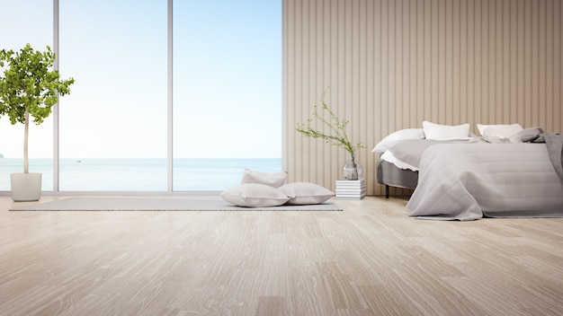 Bed op parketvloer van lichte slaapkamer tegen houten hoofdeinde in modern strandhuis of luxehotel.