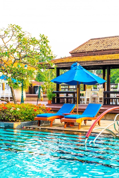 bed pool and umbrella around swimming pool in hotel resort