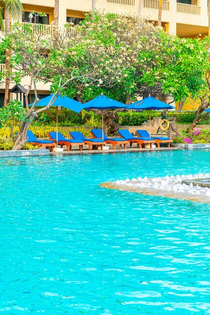 bed pool and umbrella around swimming pool in hotel resort