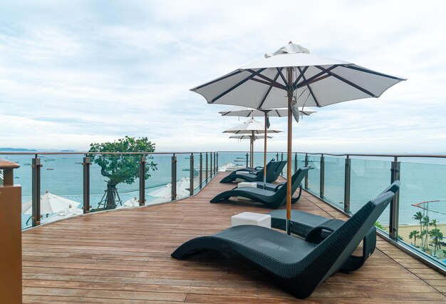 Bed pool with umbrella around swimming pool