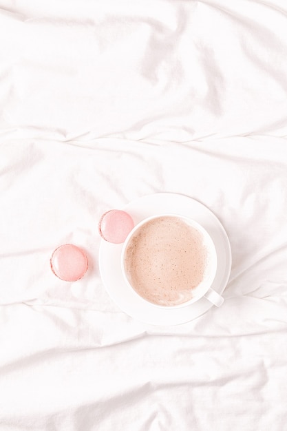 Bed with coffee and macaroons