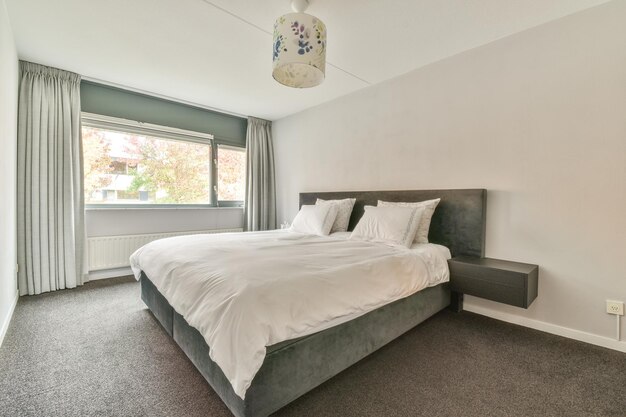 Bed with colorful pillows near window