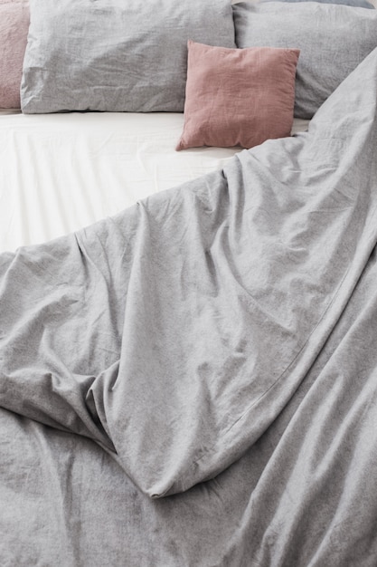 Photo bed with gray and pink  linens top view