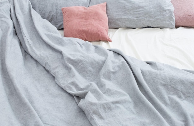 Bed with gray and pink linens