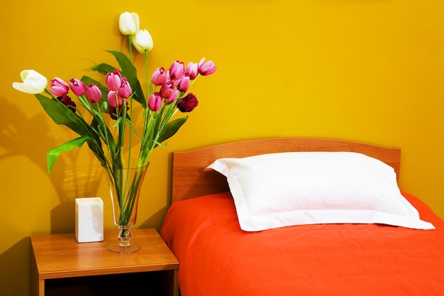 Bed with an orange coverlet