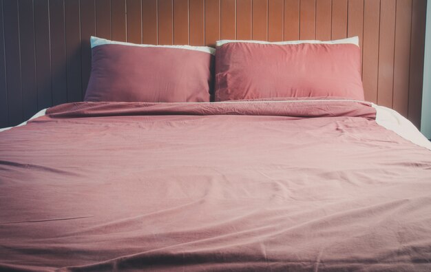 Bed with pillows and brown bedspread