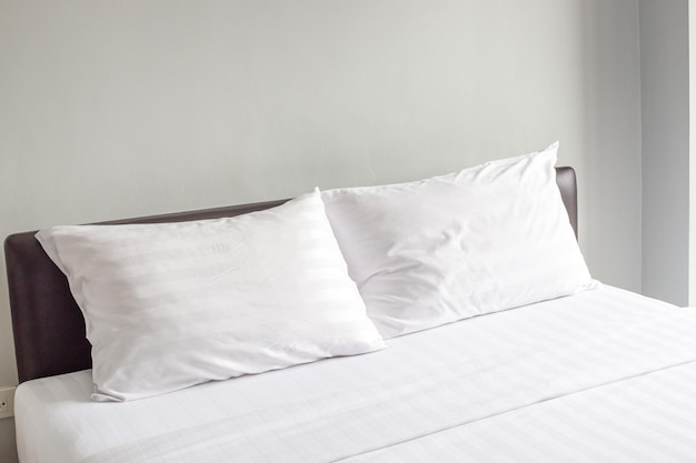 bed with pillows and neatly made white bed linen comfortable sleep and rest in the bedroom