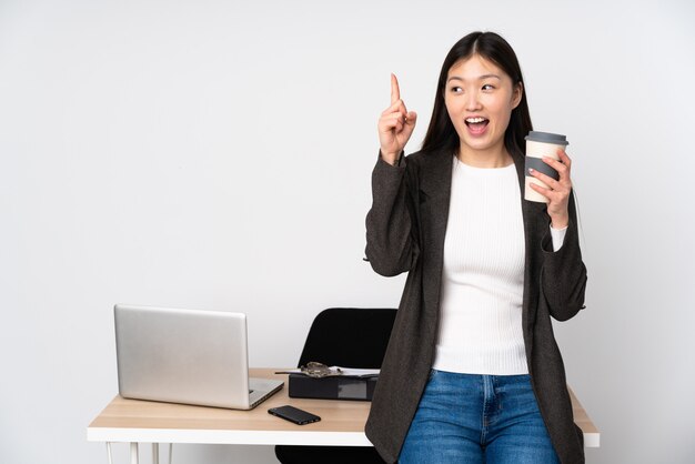 Bedrijfs Aziatische die vrouw in haar werkplaats op witte muur wordt geïsoleerd die de oplossing willen realiseren terwijl het opheffen van een vinger