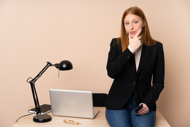 Bedrijfs vrouw in een bureau dat een idee denkt