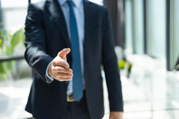 Bedrijfsmens met een open hand klaar om een overeenkomst te verzegelen