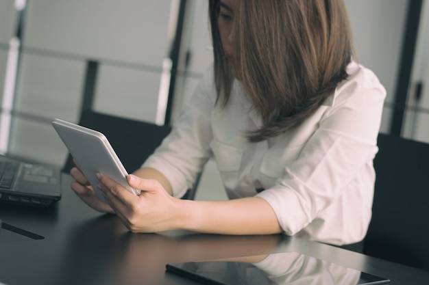 Bedrijfsvrouw die tablet op lijst gebruiken