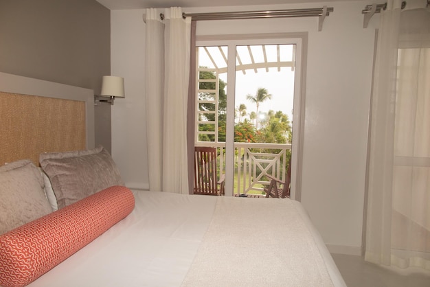 Bedroom in soft light colors big comfortable double bed in elegant classic bedroom