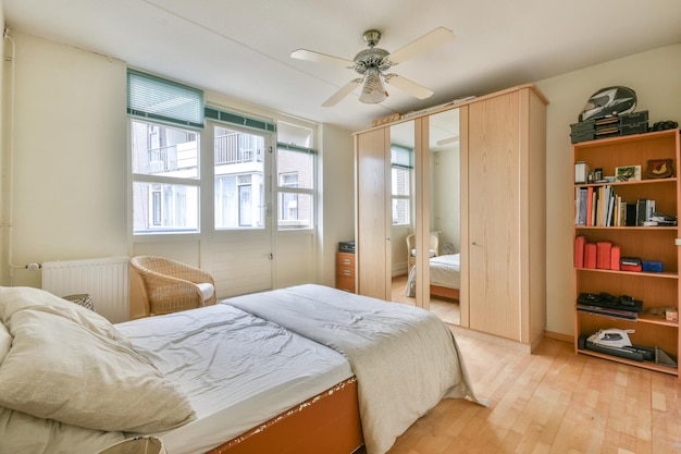 A bedroom with a bed and a ceiling fan