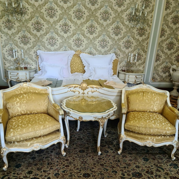 A bedroom with a bed and chairs