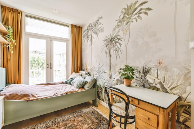 A bedroom with a bed and a desk and plants