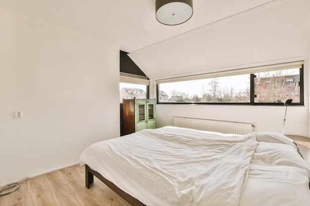 A bedroom with a bed and a large window