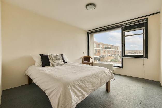 A bedroom with a bed and a window