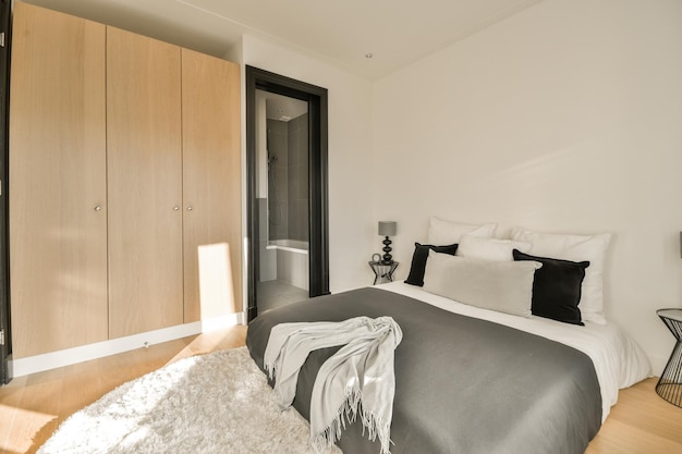 A bedroom with a bed and wooden cabinets