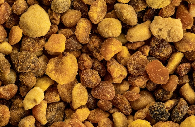 Bee pollen blobs or granules, individual spheres visible. 1.5x magnification, image width 23mm