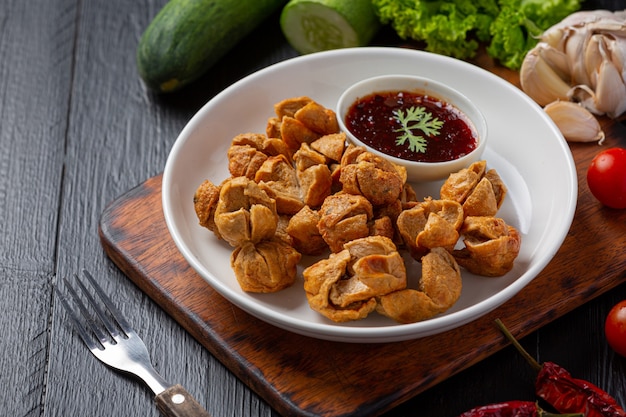 Beef ball fried on the dark wooden surface.