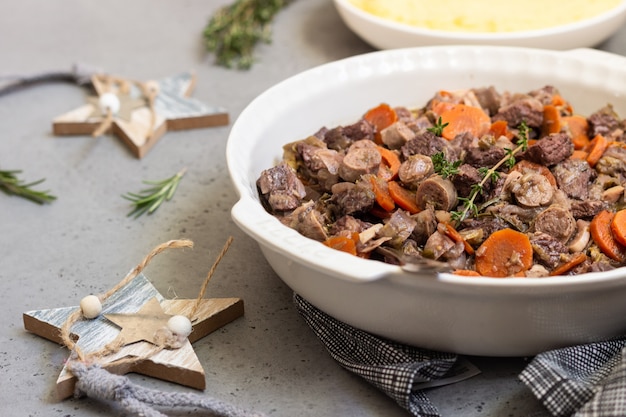 Beef bourguignon or meat stew with vegetables and herbs.