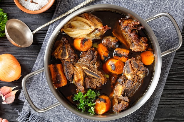 Beef broth of beef meat on bones with spices