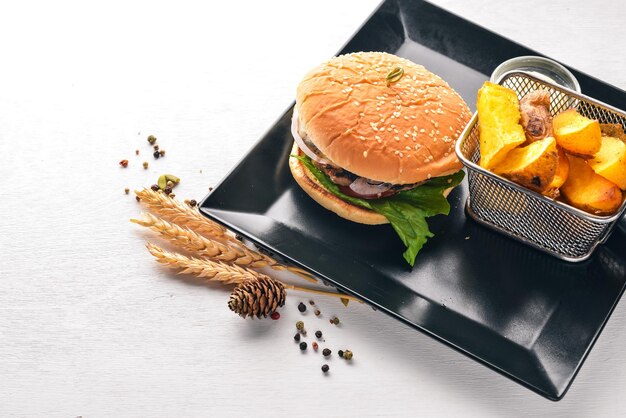 Beef burger Potato frying On a wooden background Top view Free space for text