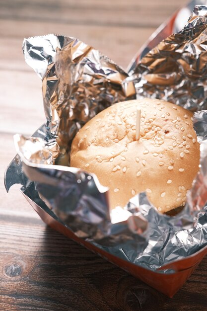 Beef burger in a take away box on table