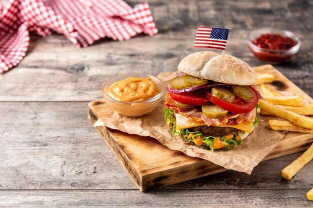 Beef burger with bacon on rustic wooden table