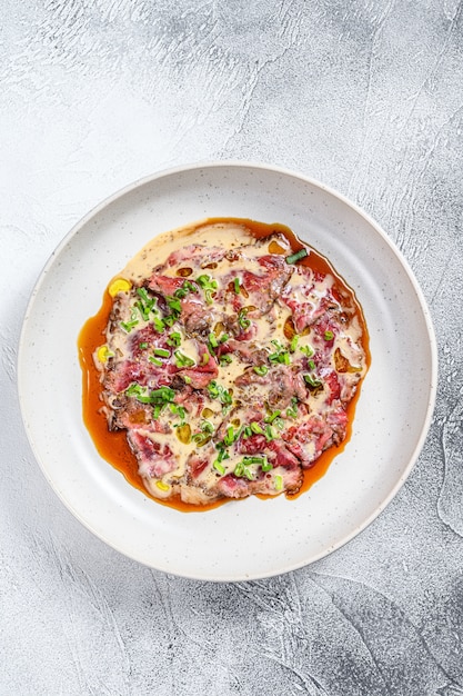 Beef carpaccio with fresh green onions