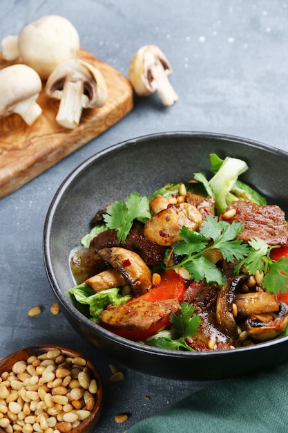 Beef and champignons with pine nuts