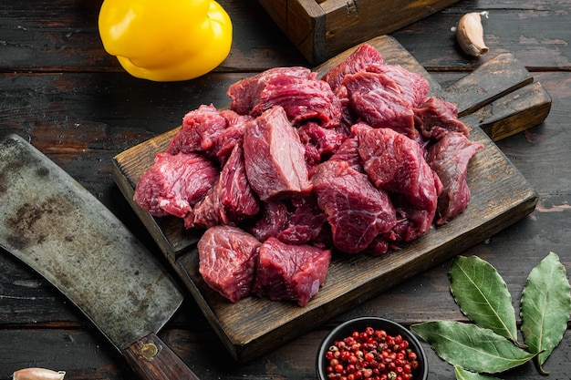 Beef chuck stew ingredients  set with sweet bell pepper, on old dark  wooden table