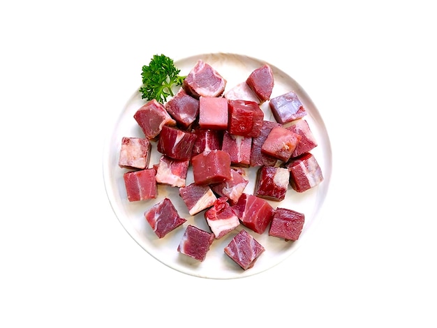 Beef cut into pieces and served on a white plate isolated on white