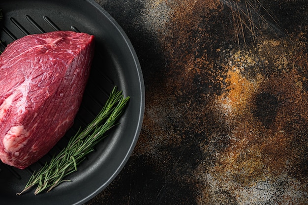 Beef cut raw set, on frying iron pan, on old dark rustic