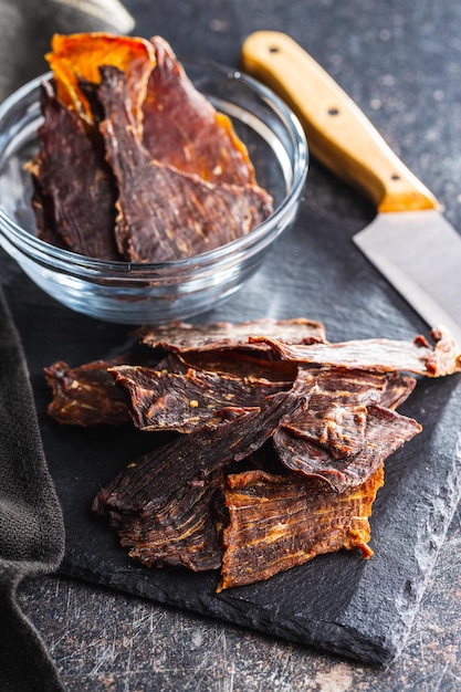 Beef jerky meat dried sliced meat on cuting board