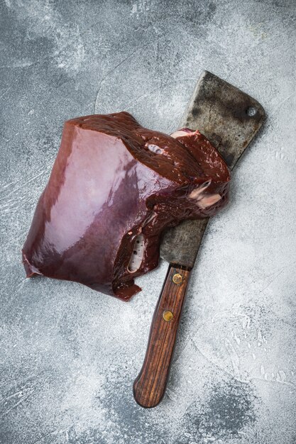 Beef liver on grey background, top view.