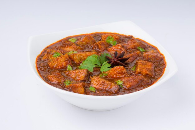 Beef masala or curry homemade recipe arranged in white bowl  with white background