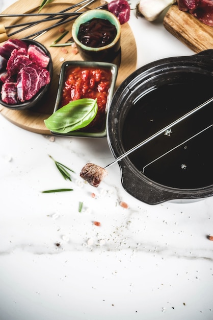 Beef meat fondue, with different sauces, top view copy space