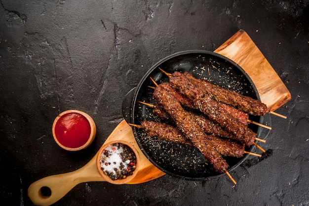 Beef meat shish kebab on a sticks with ketcup sauce