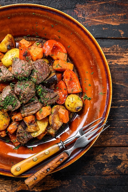 Beef meat stewed with vegetables on a plate