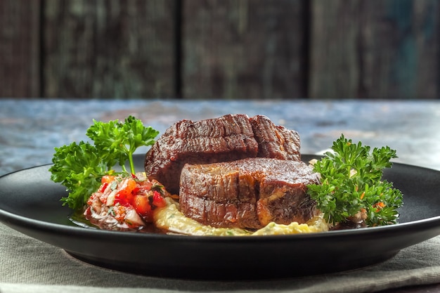 Beef medallions with tomato salsa and cream polenta